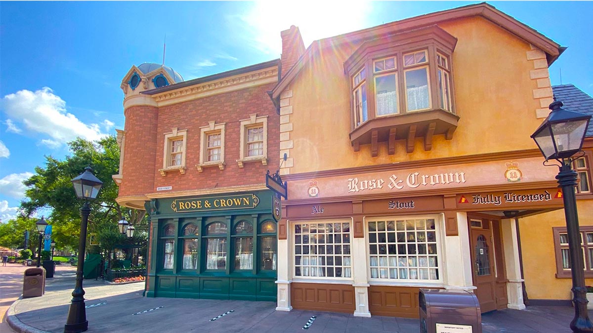 exterior of Rose & Crown Dining Room with street lamps and sun shining down on roof at Epcot in Orlando, Florida, USA